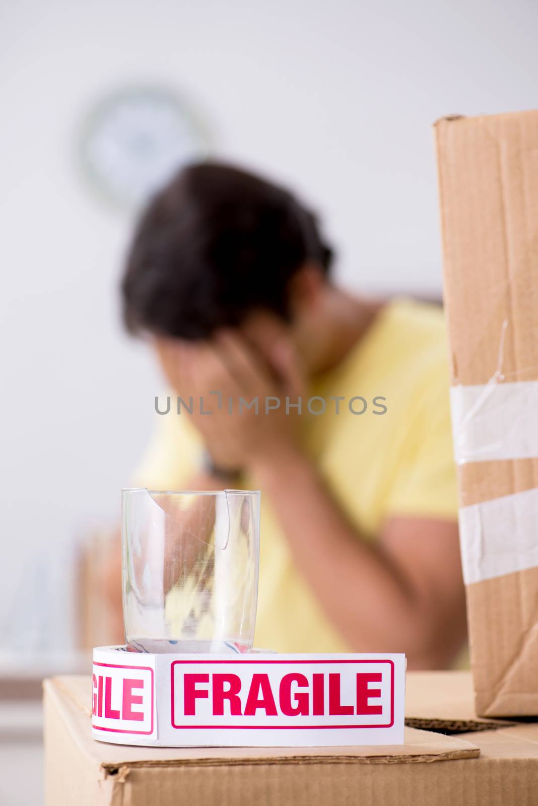 Man moving house and relocating with fragile items