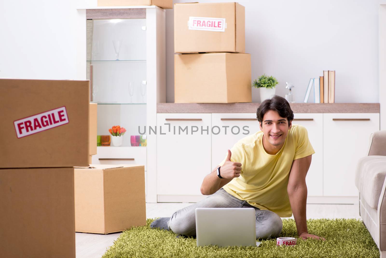 Man moving house and relocating with fragile items