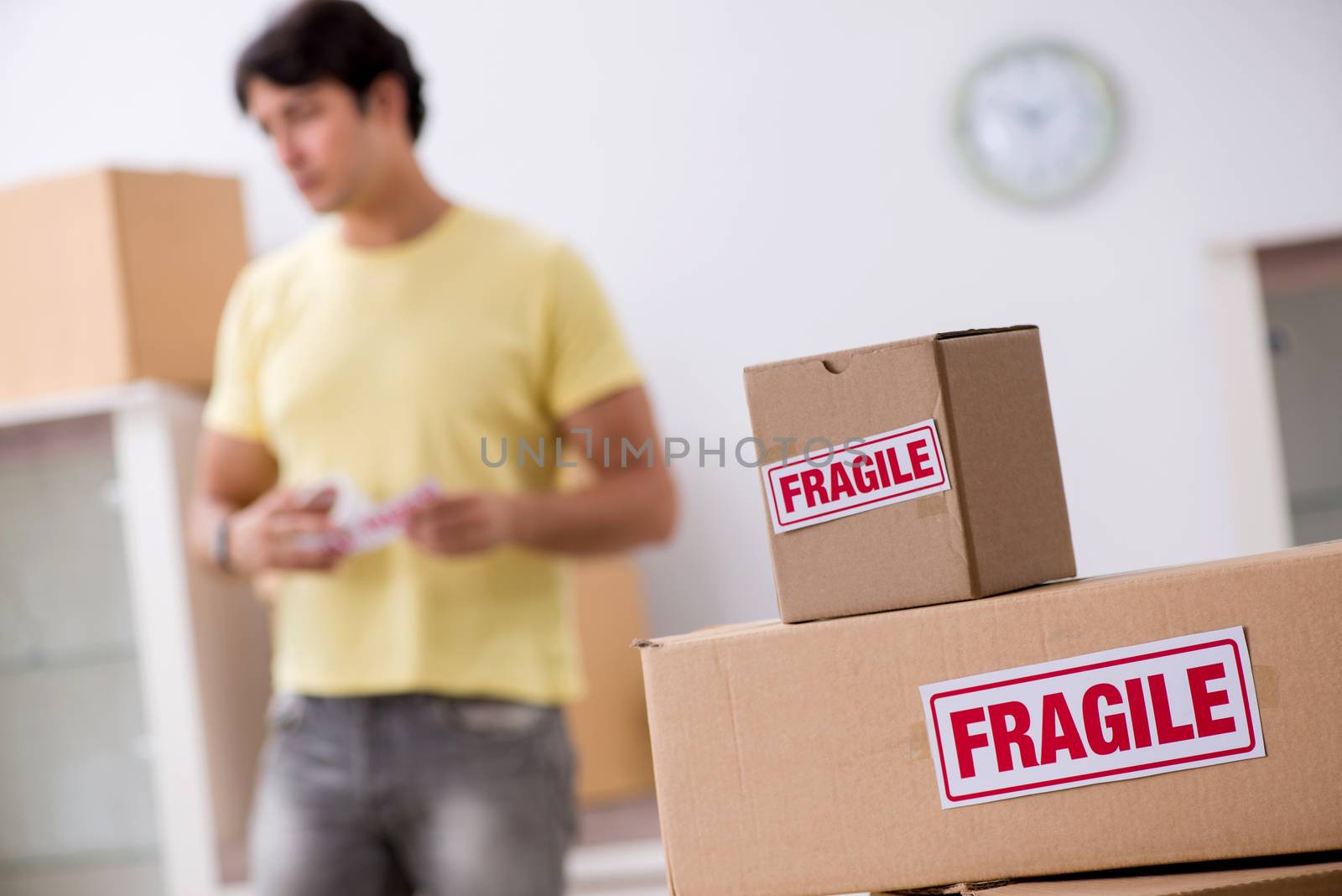 Man moving house and relocating with fragile items