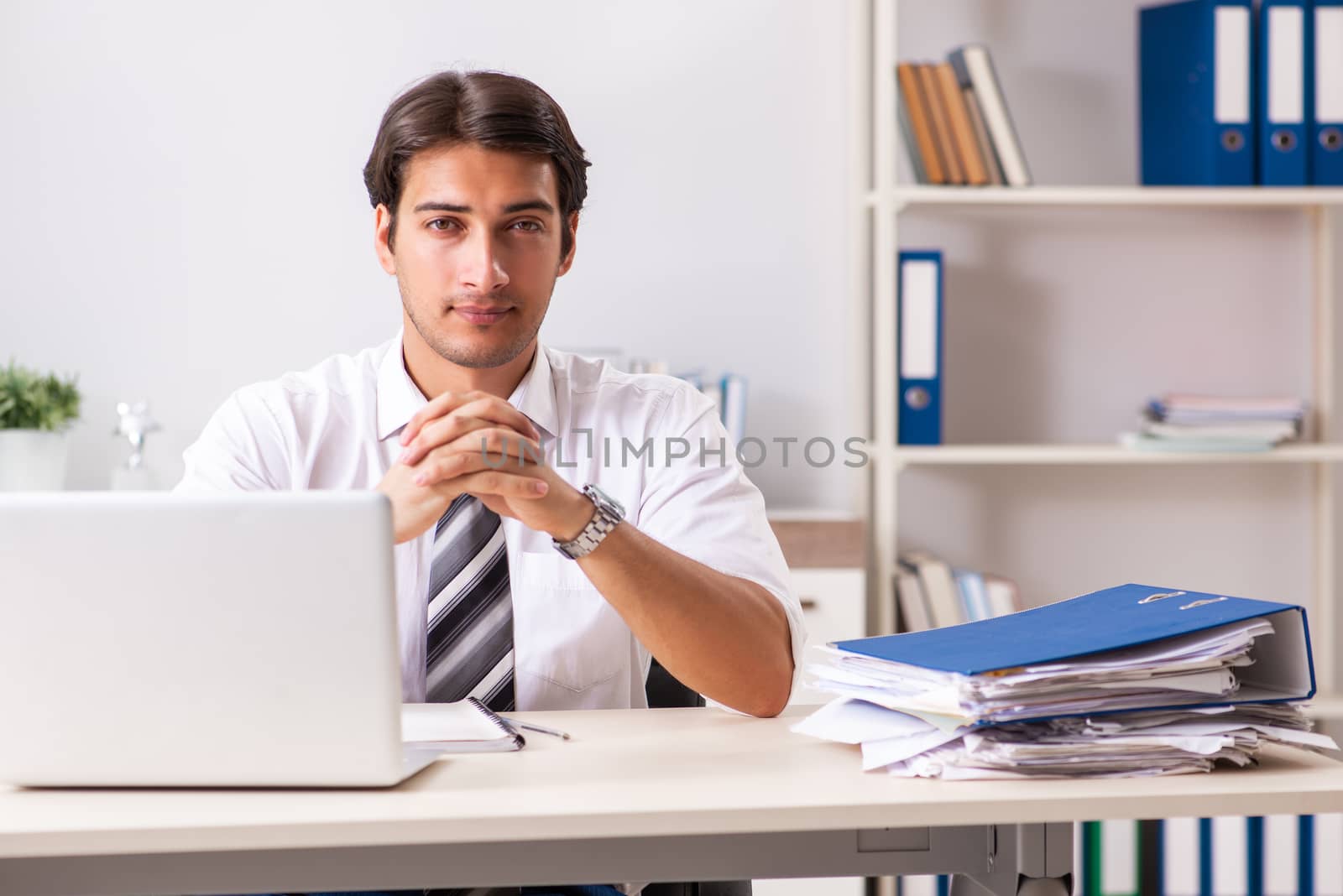 Young handsome businessman working in office