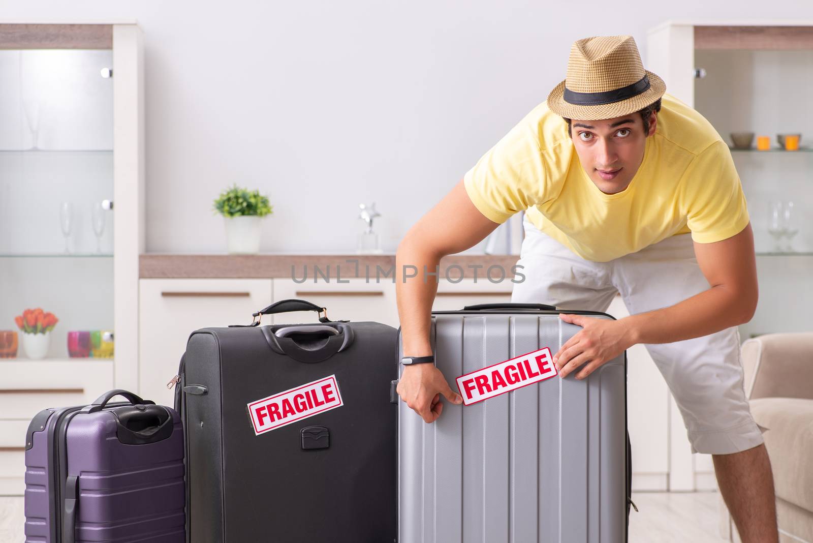 Man going on vacation with fragile suitcases