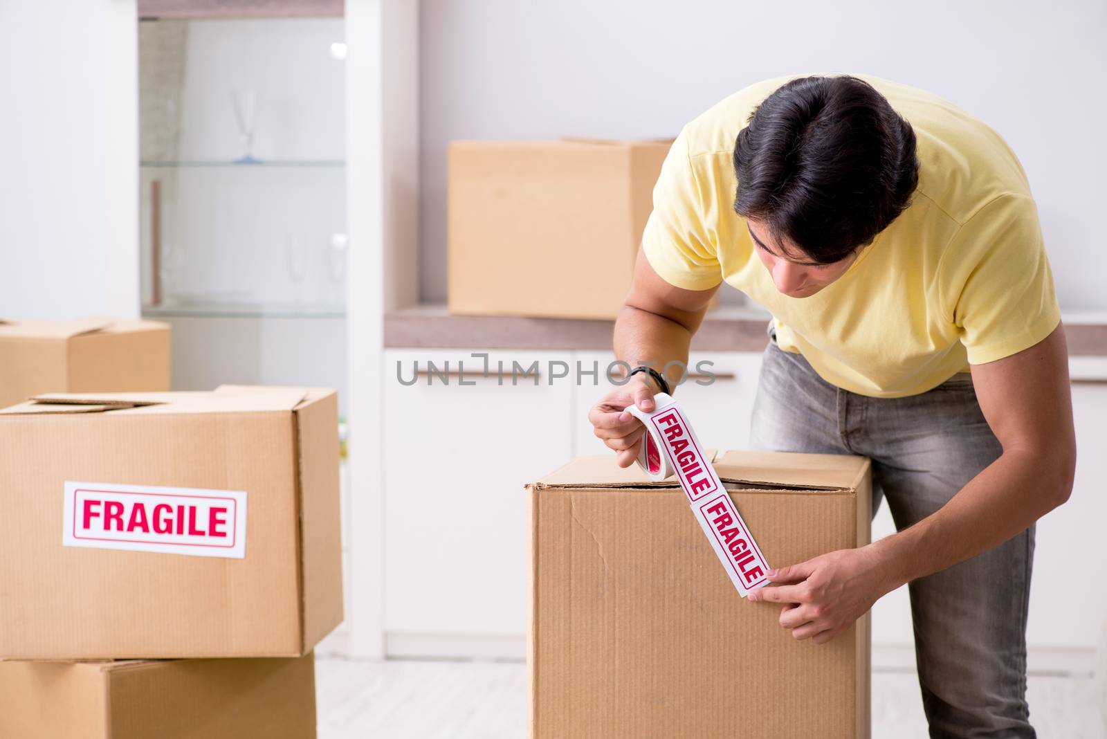 Man moving house and relocating with fragile items