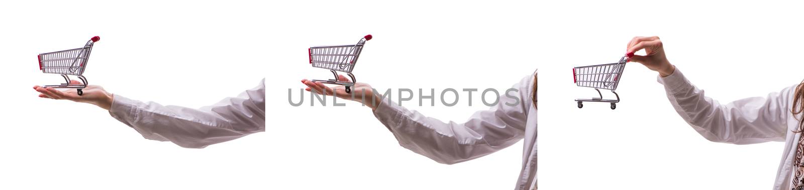 Hand holding shopping cart isolated on white
