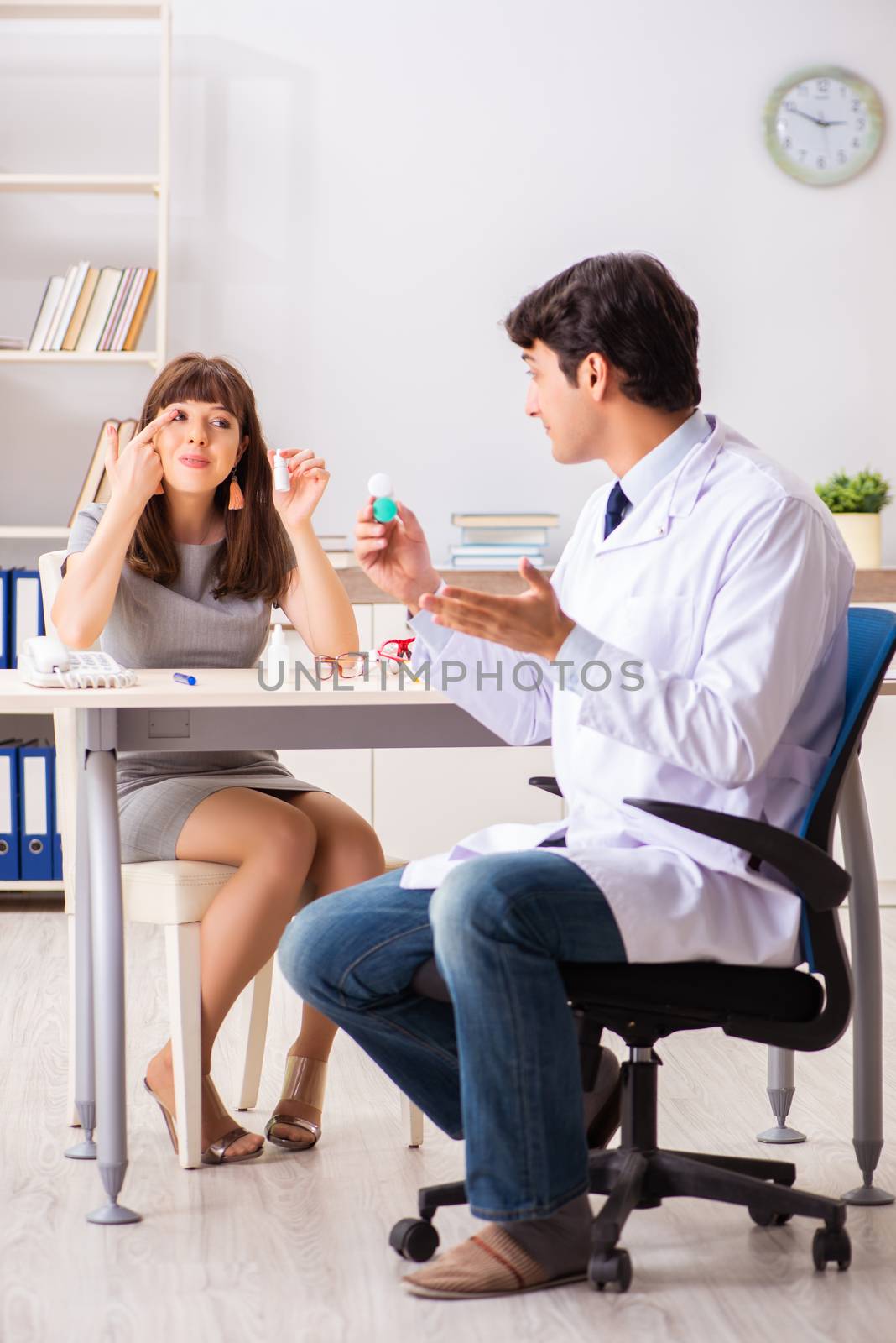 Young woman visiting male doctor ophthalmologist in hospital