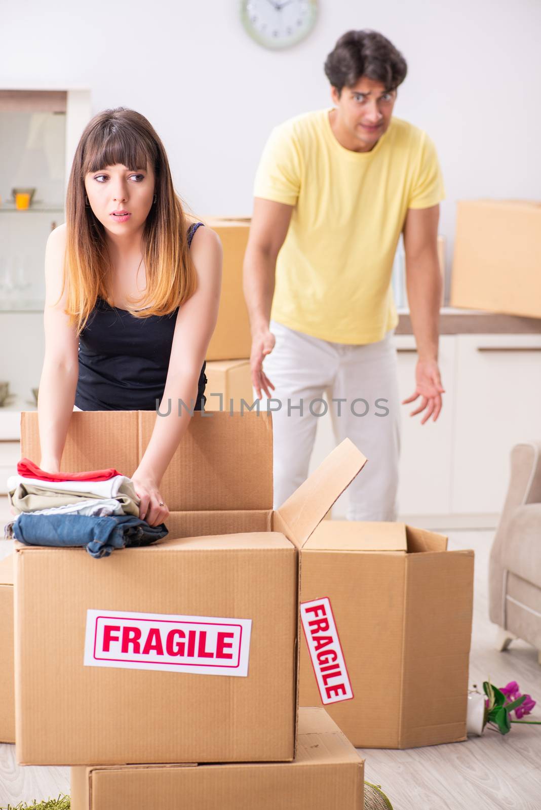 Young couple moving to new flat with fragile things by Elnur