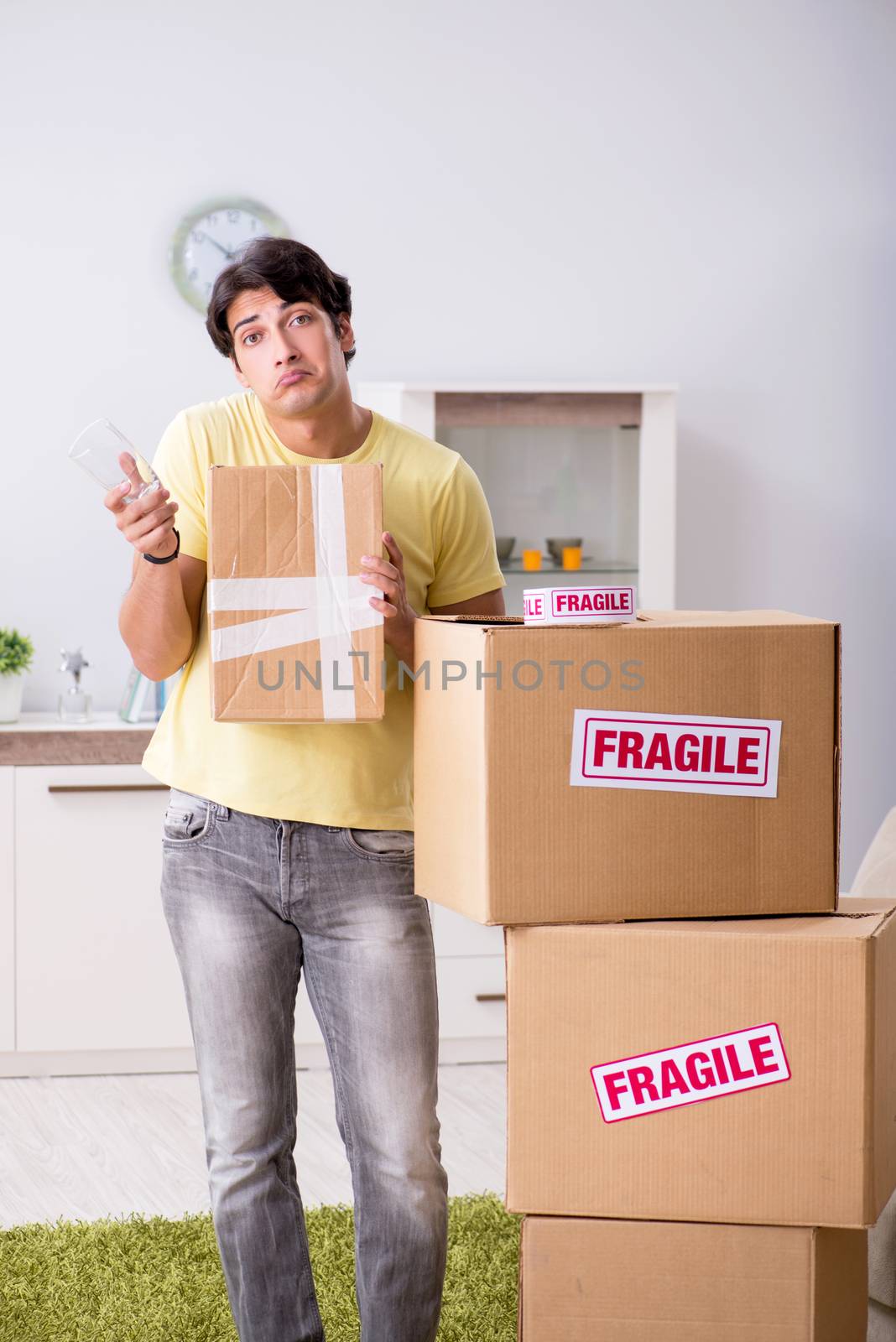 Man moving house and relocating with fragile items