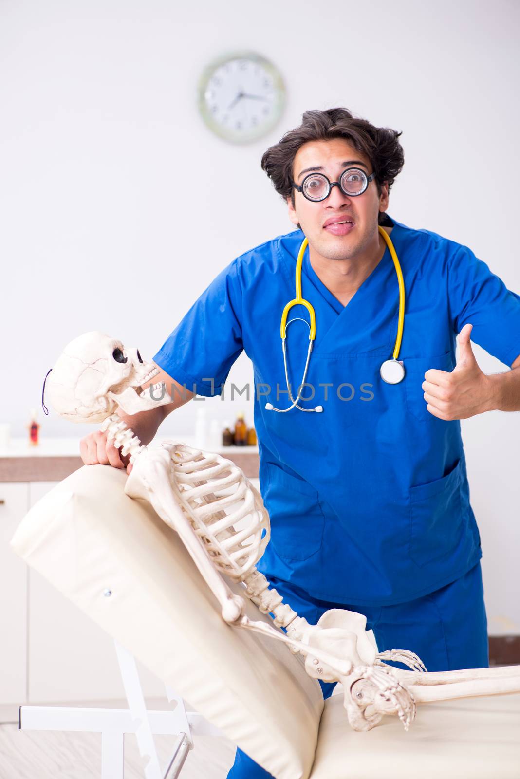 Funny doctor with skeleton in hospital by Elnur