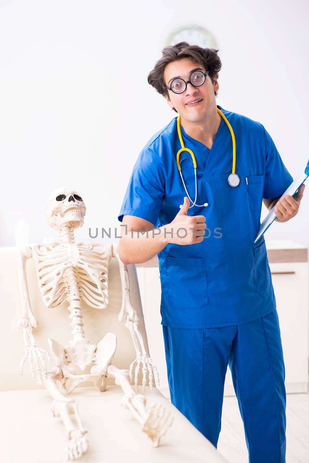 Funny doctor with skeleton in hospital by Elnur