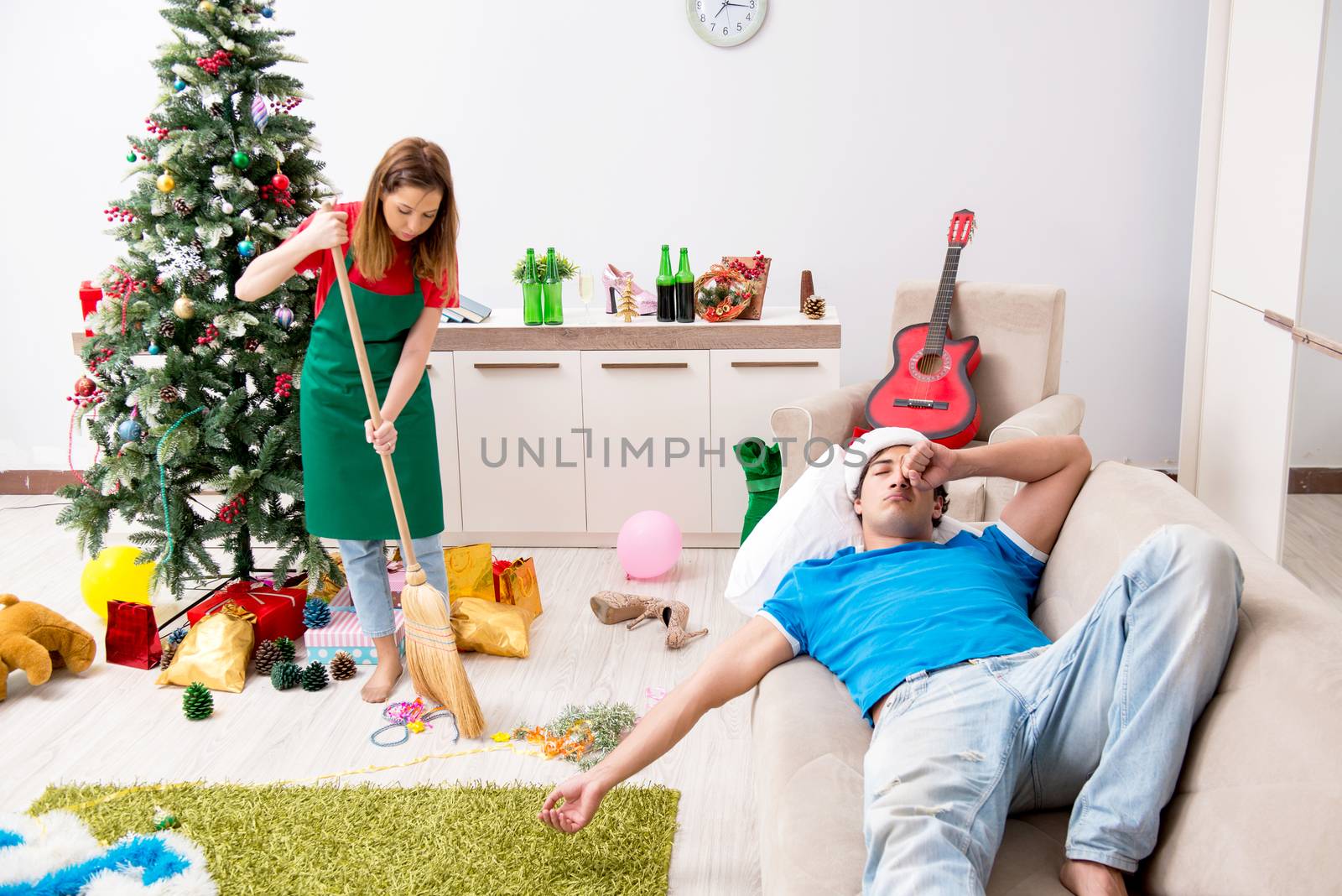 Young family cleaning apartment after christmas party