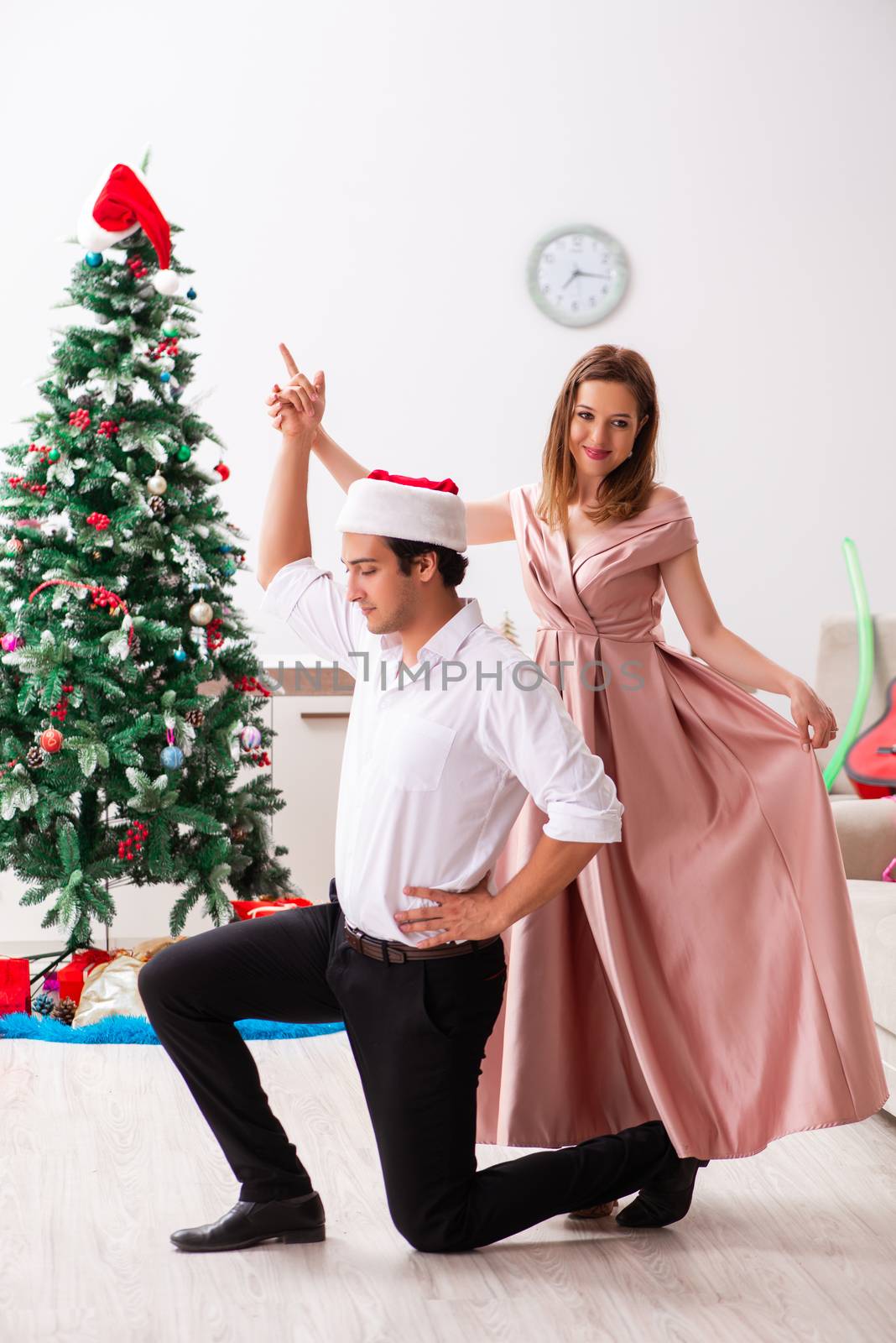 Young pair celebrating christmas at home