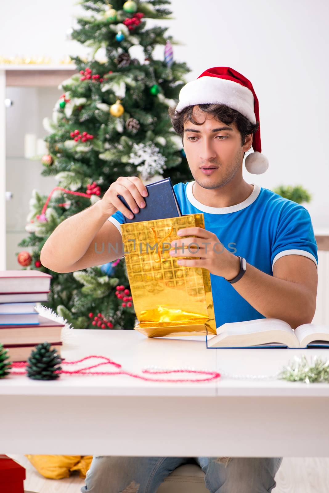 Young student with book at Christmas eve 