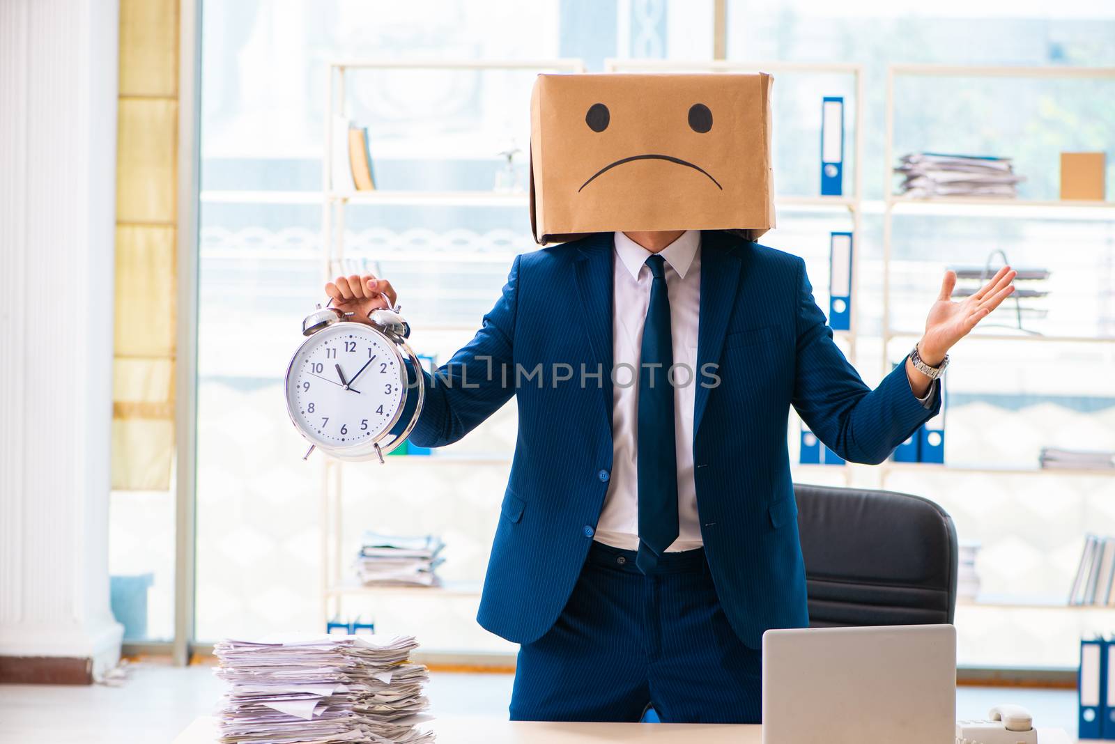 Unhappy man with box instead of his head 
