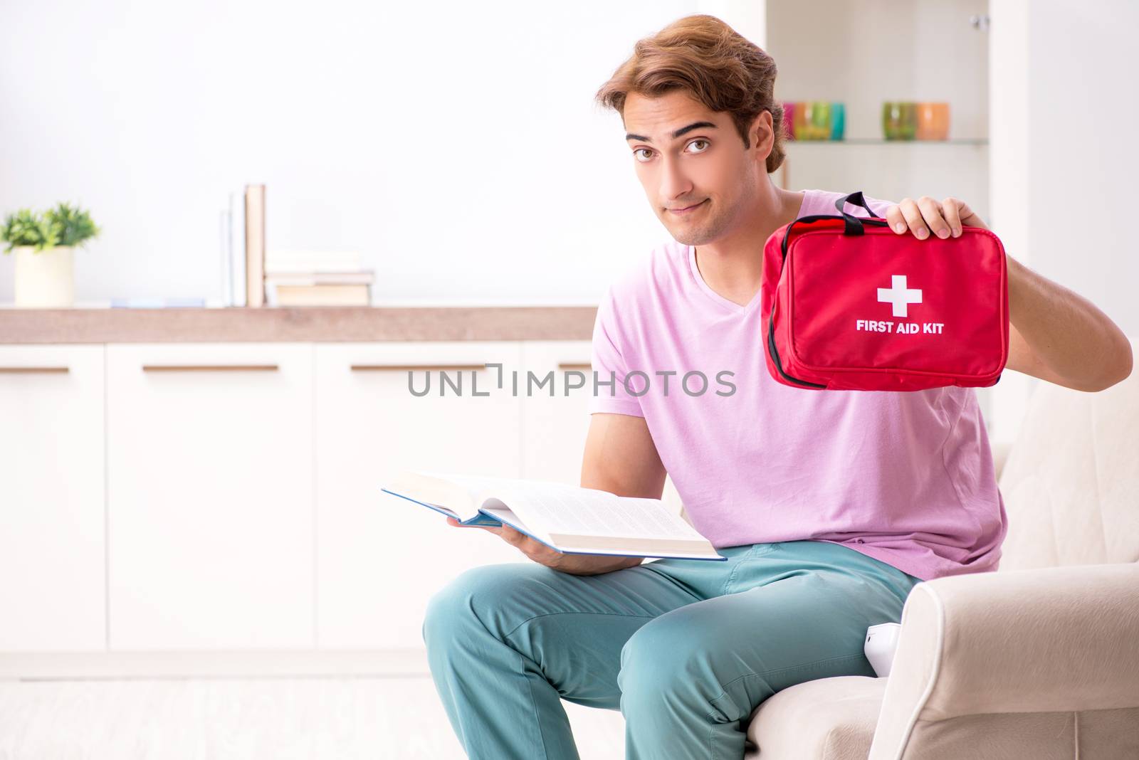 Sick man at home with first aid kit