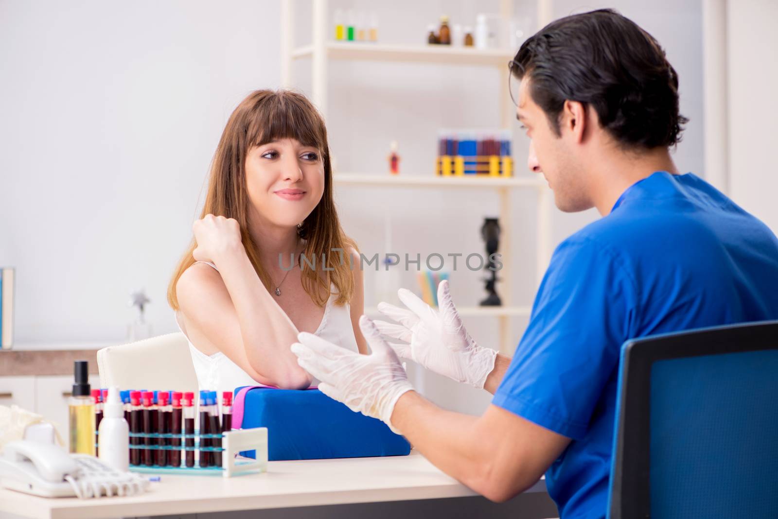 Young patient during blood test sampling procedure  