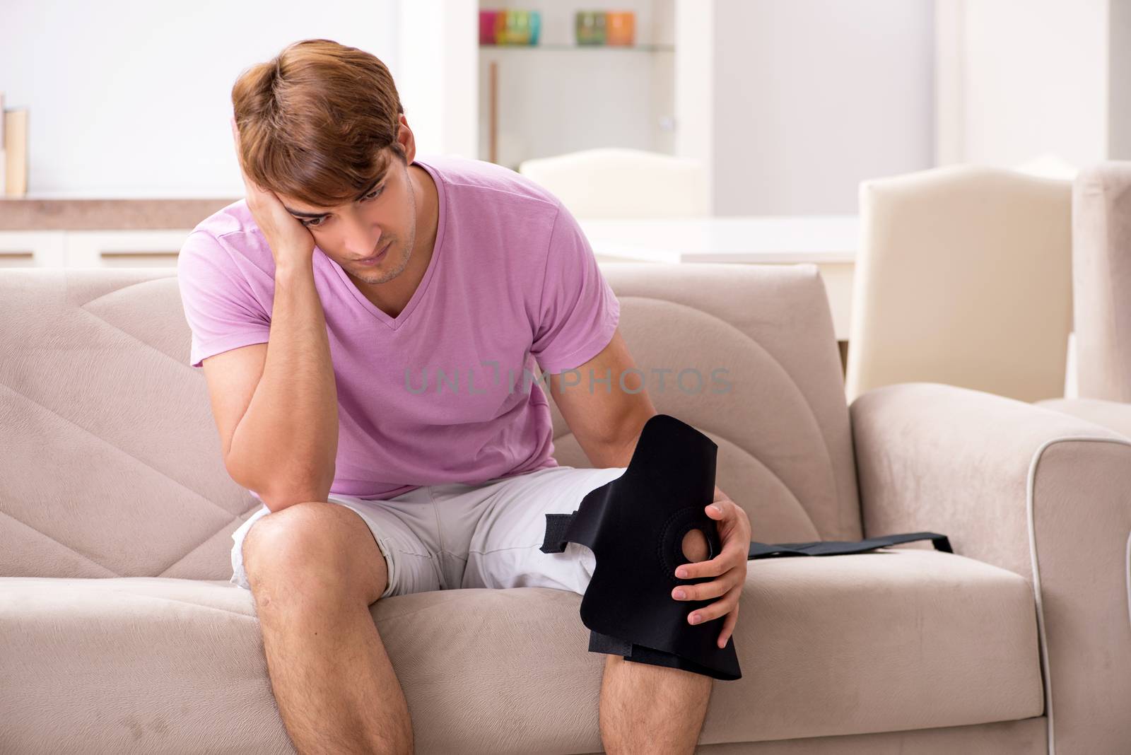 Injured man recovering at home from sports injury