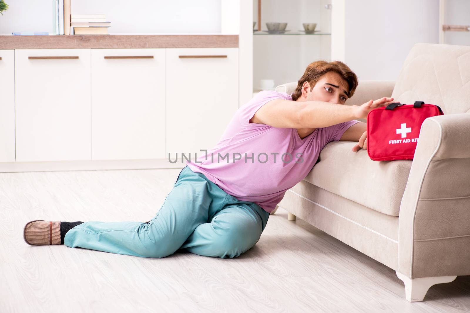 Sick man at home with first aid kit