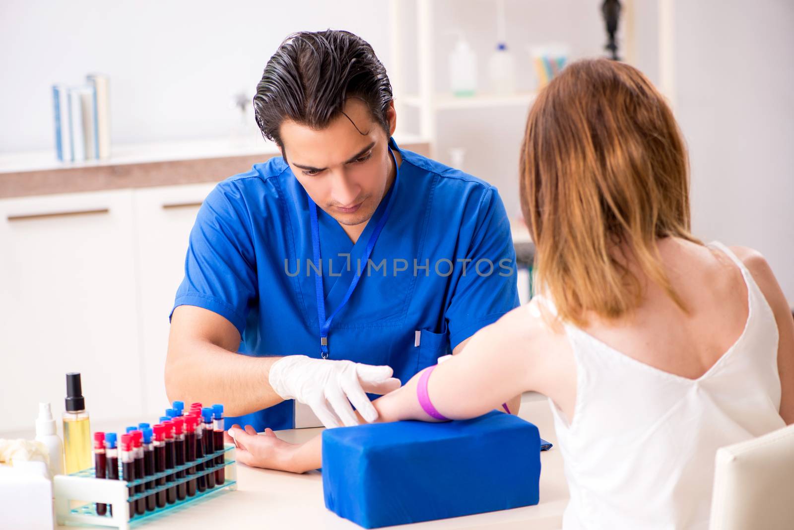 Young patient during blood test sampling procedure  