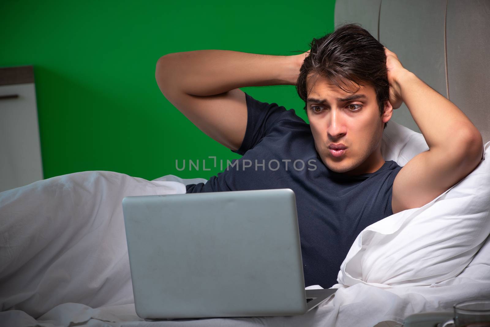 Young handsome man suffering from insomnia at home