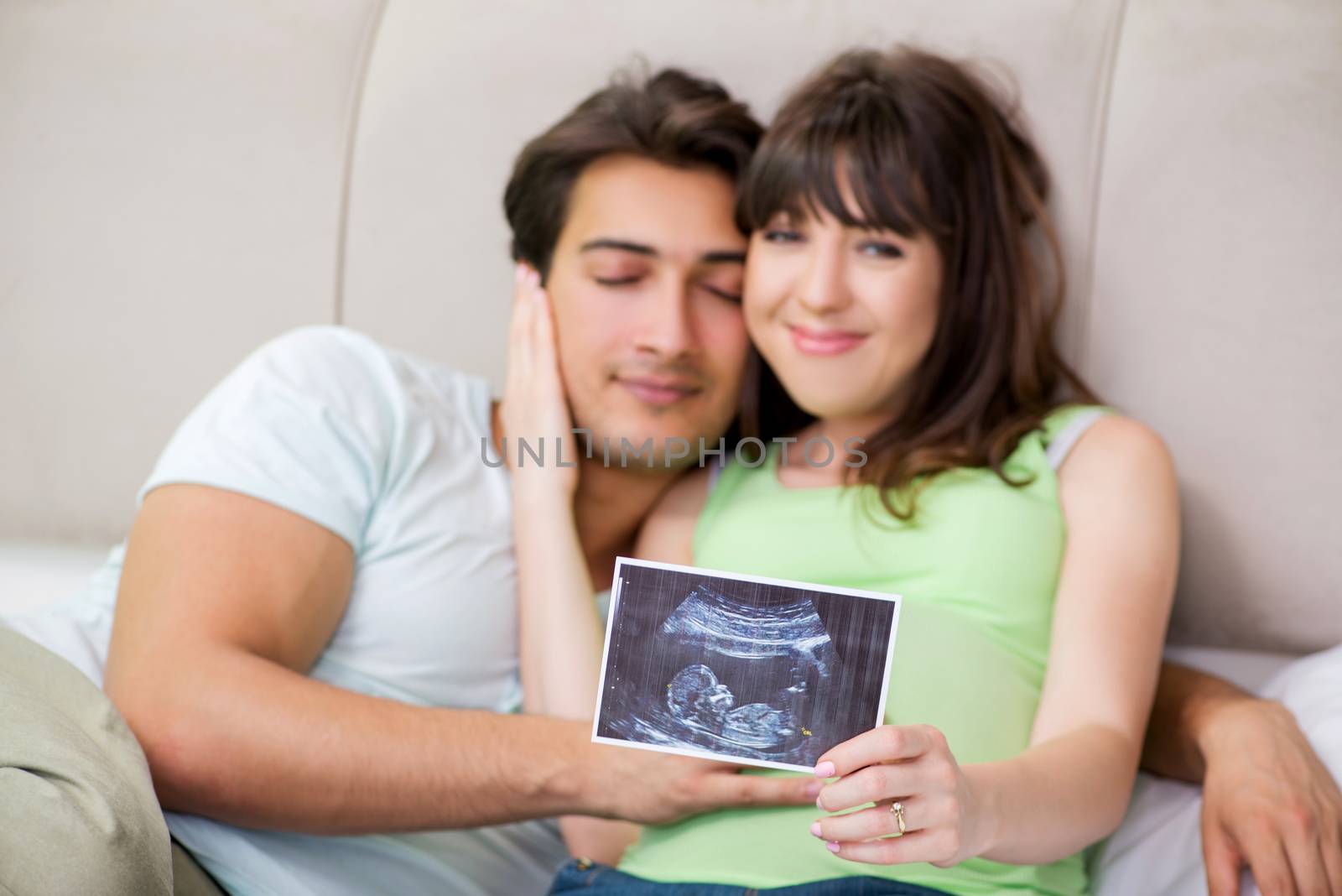 Young family finding out about pregnancy by Elnur
