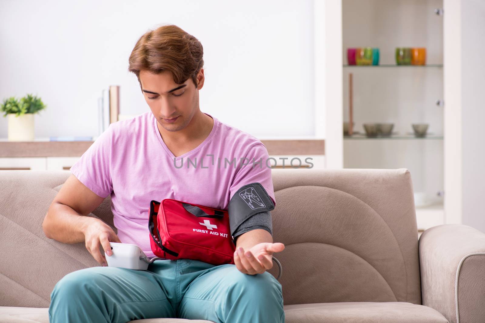 Sick man at home with first aid kit