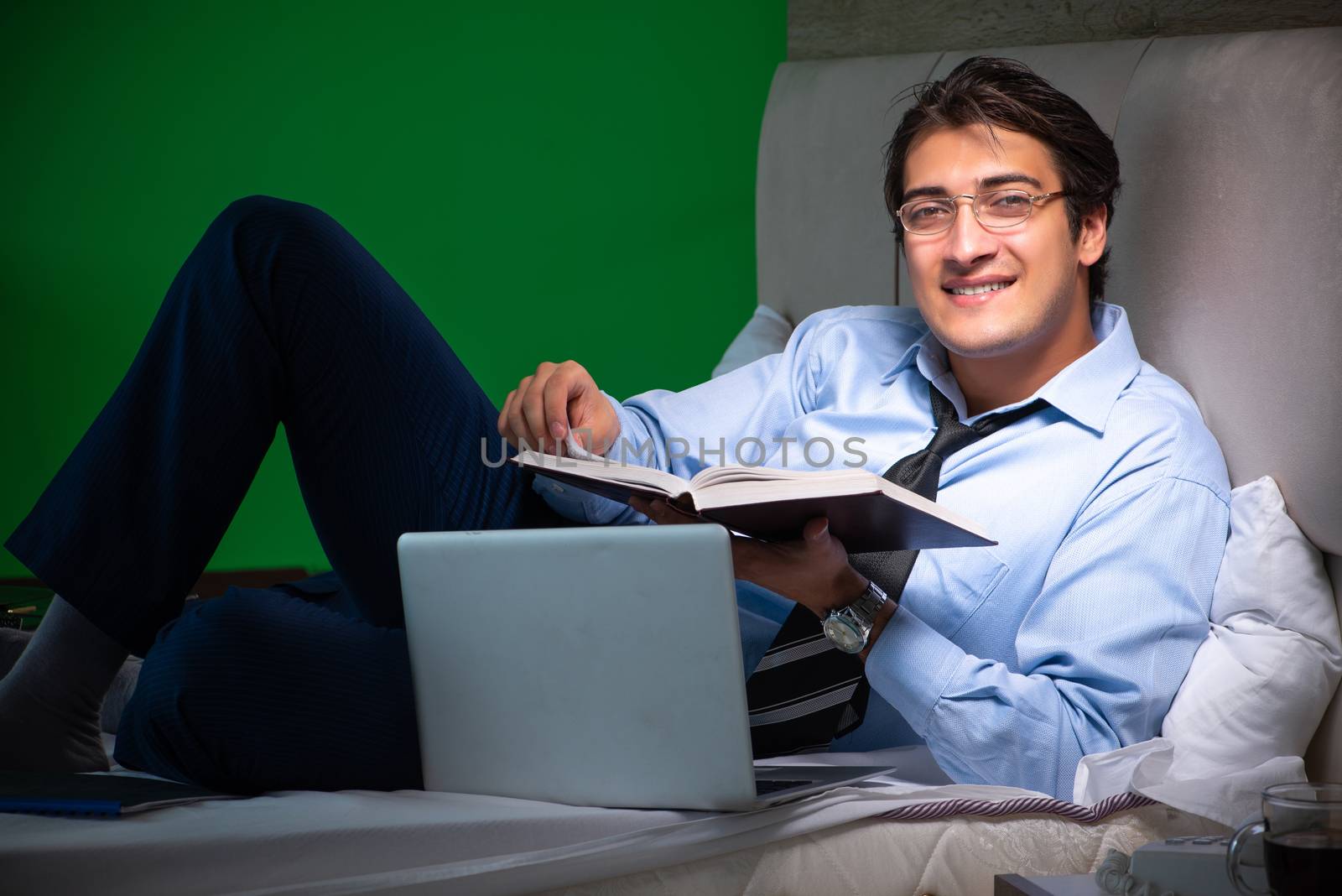 Young businessman under stress in the bedroom at night 