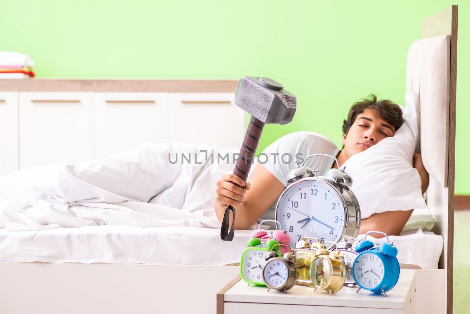 Young man having trouble waking up in early morning