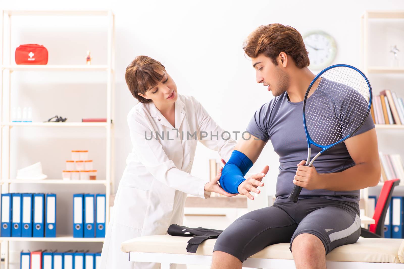 Young tennis player visiting doctor traumatologist 