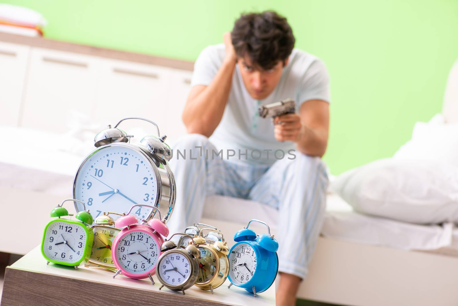 Young man having trouble waking up in early morning