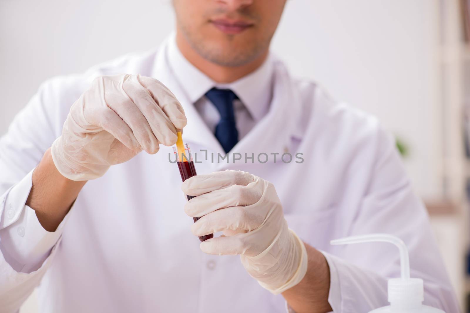 Chemist in the lab checking with ph strips