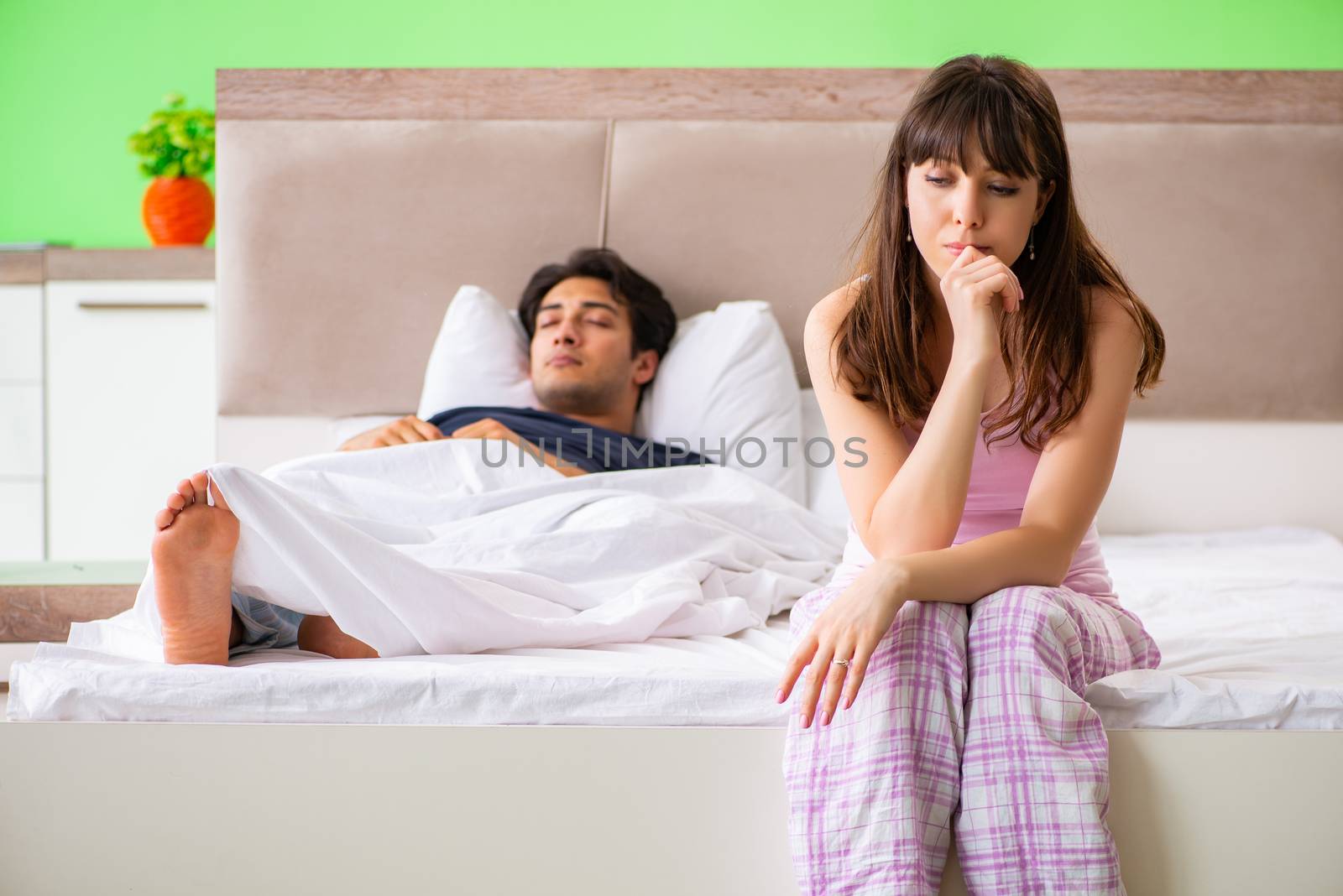 Woman and man in the bedroom after conflict