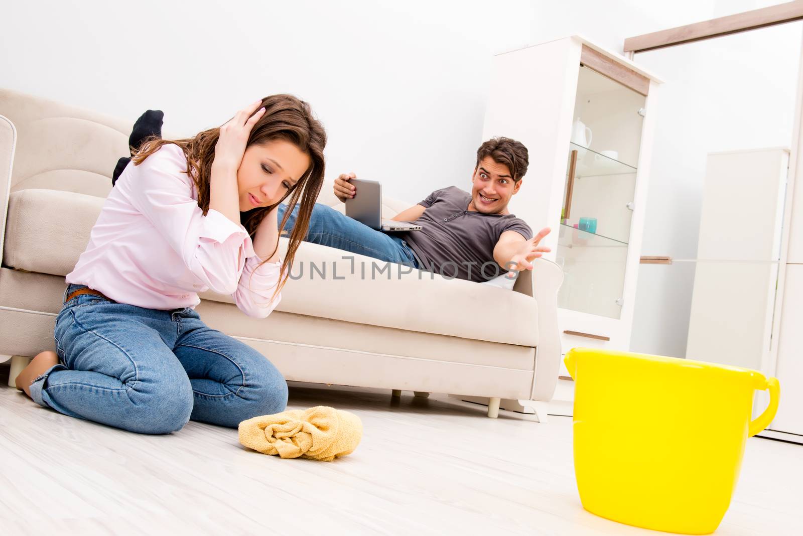 Young family doing cleaning at home by Elnur