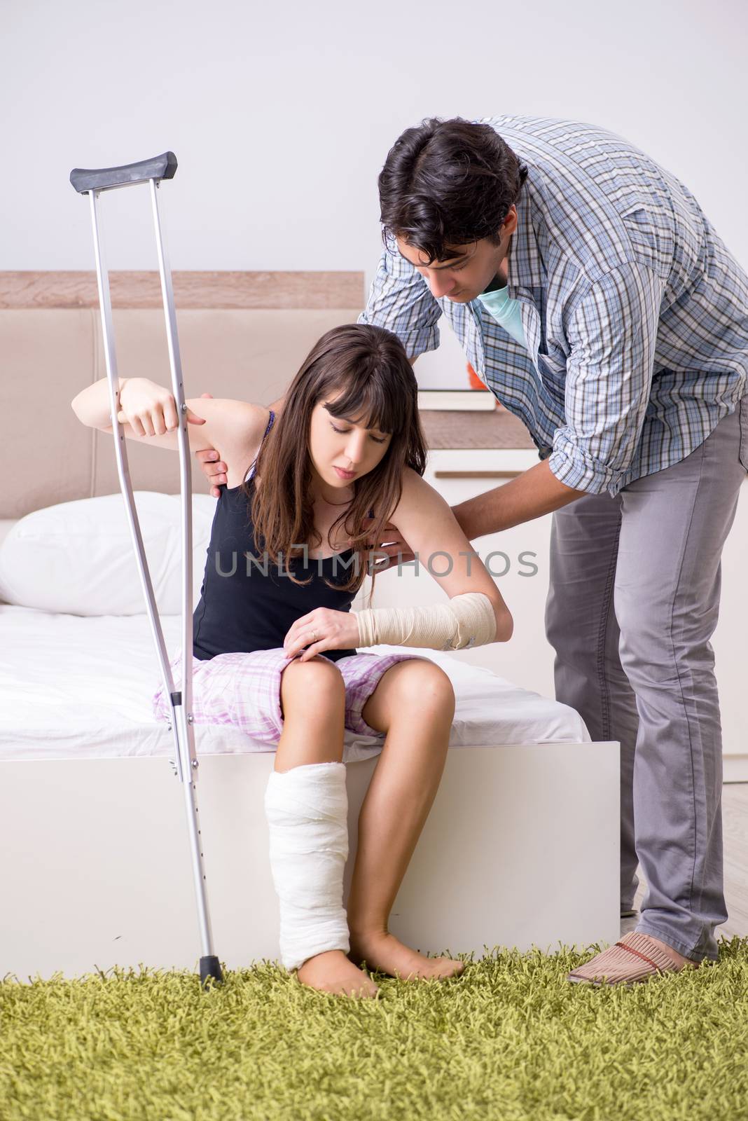 Caring husband looking after his injured wife by Elnur