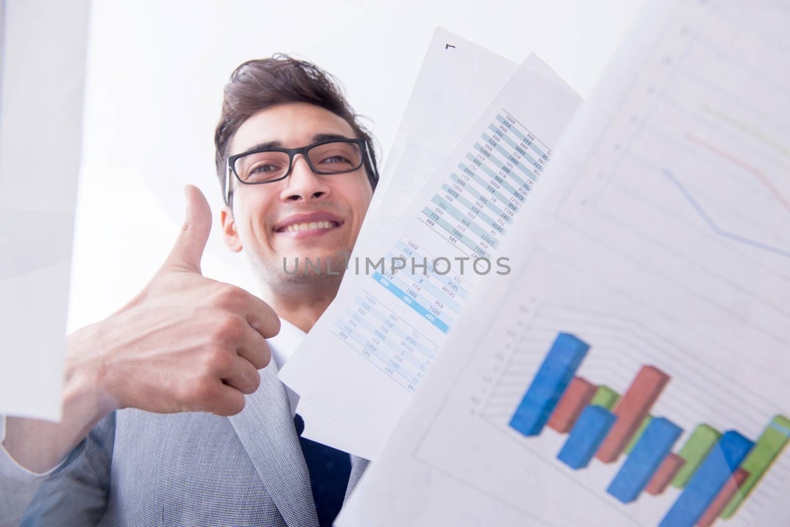 Businessman looking at financial charts and graphs