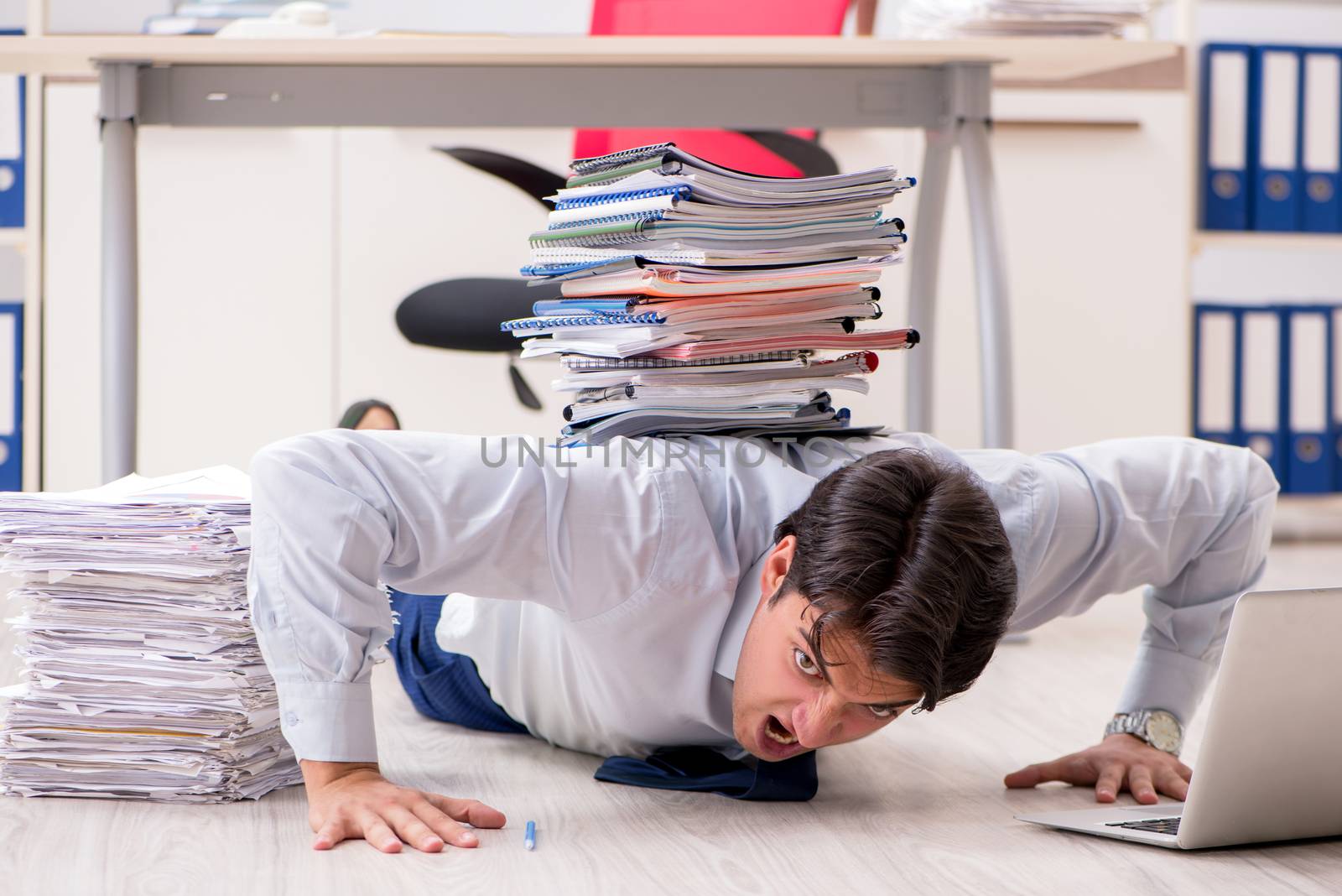 Extremely busy employee working in the office