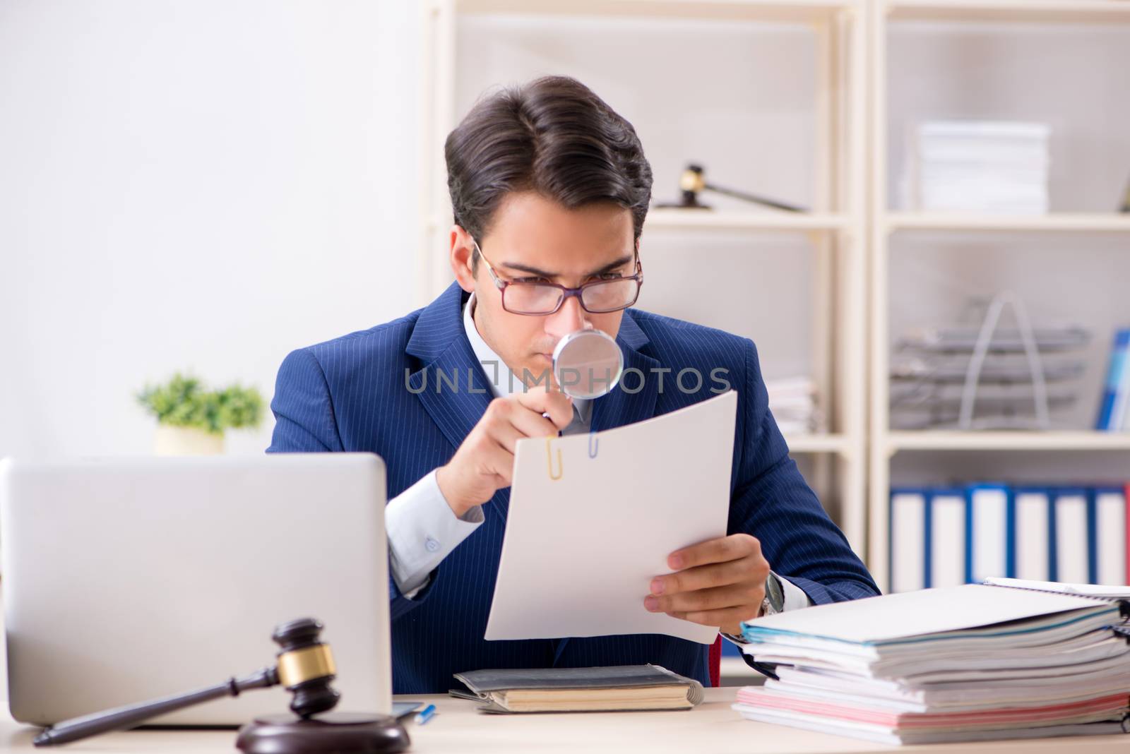 Young handsome judge working in court