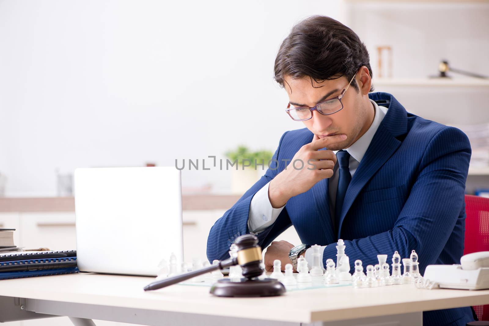 Young lawyer playing chess to train his court strategy and tactics