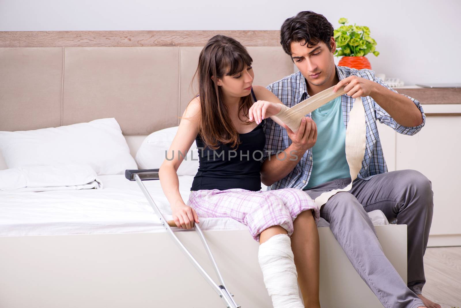 Caring husband looking after his injured wife