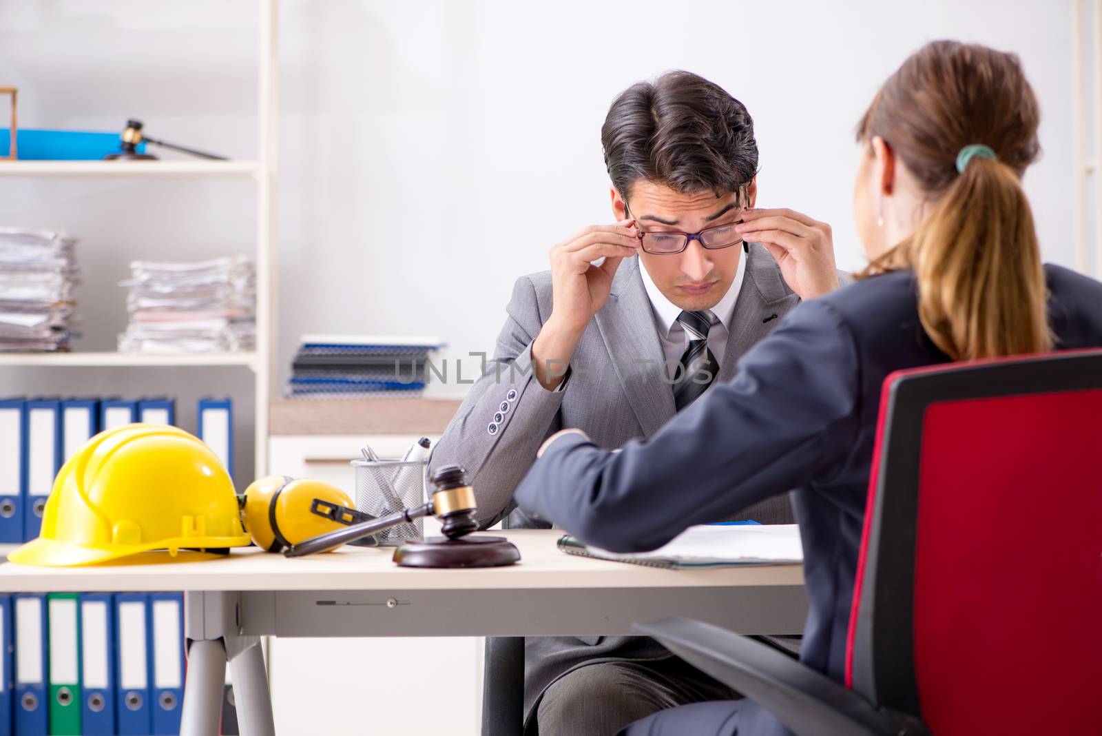 Lawyer talking to client in office