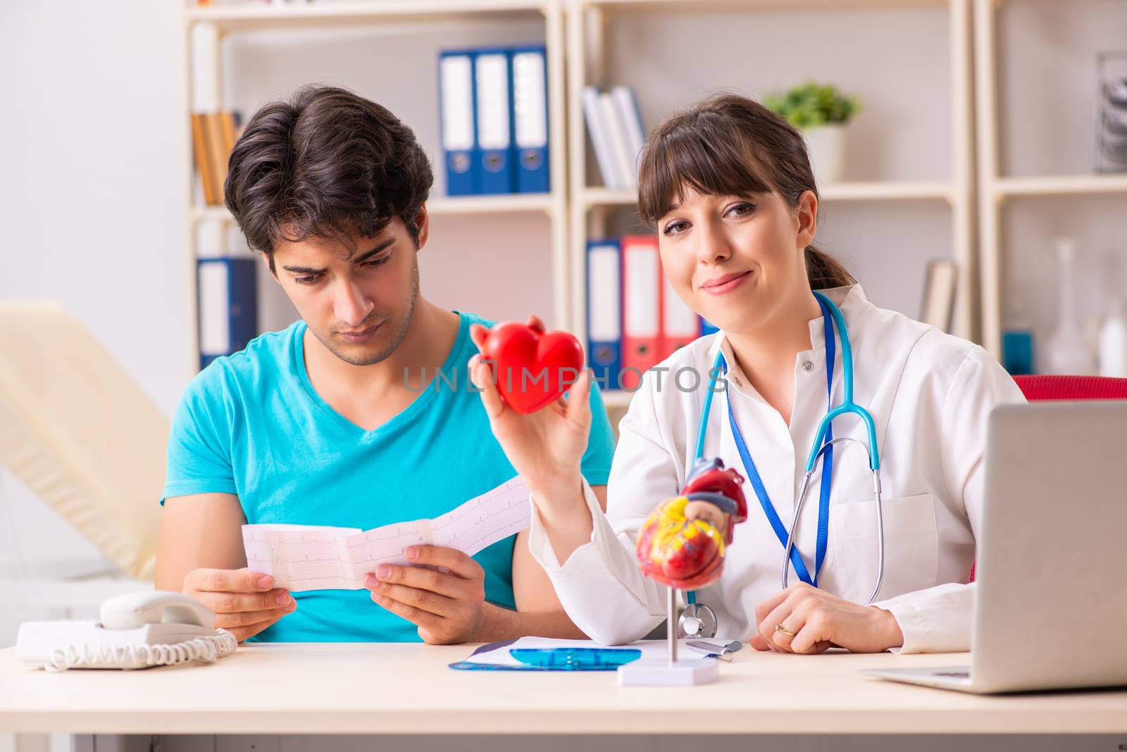 Young man visiting female doctor cardiologist 