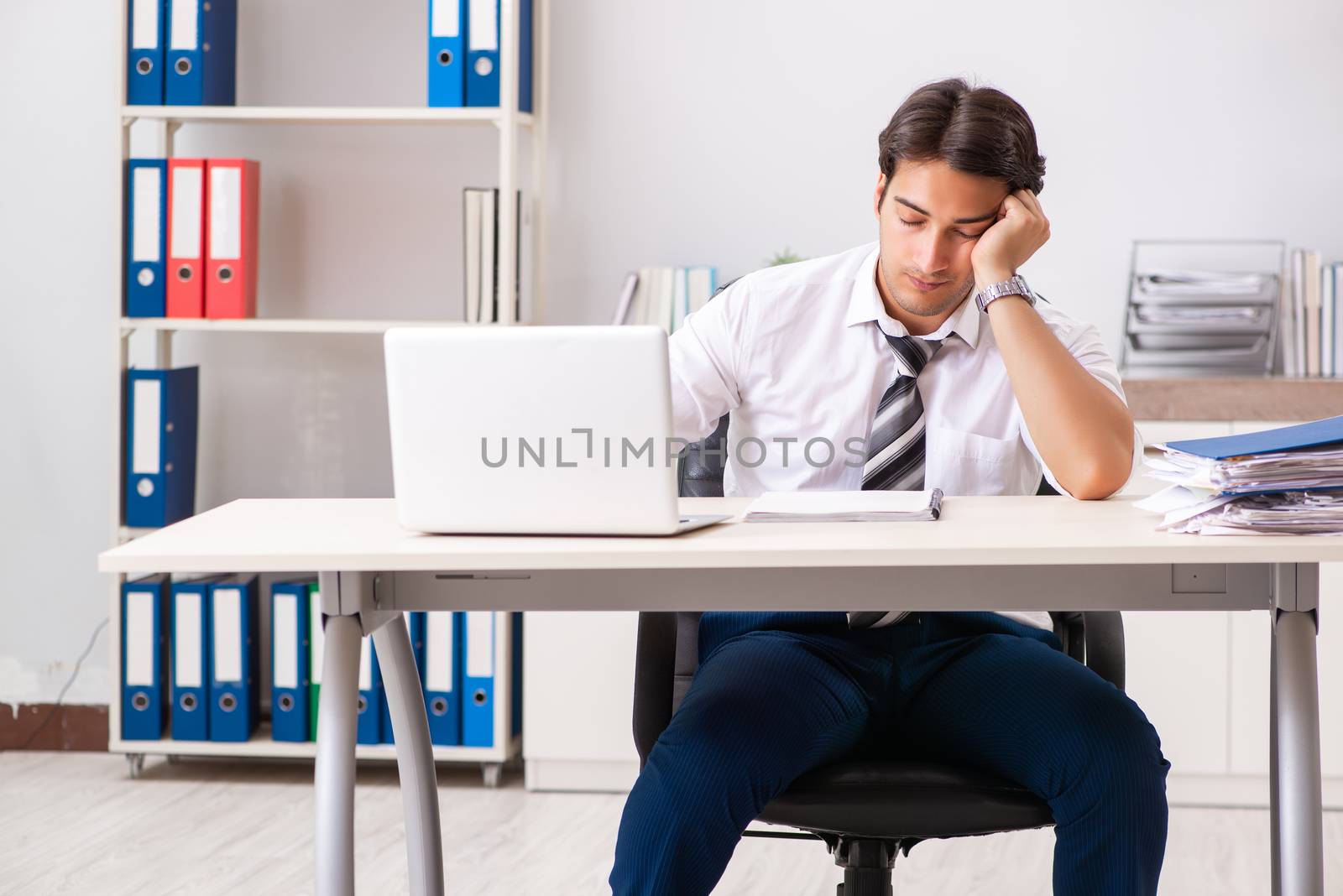 Young handsome businessman working in office