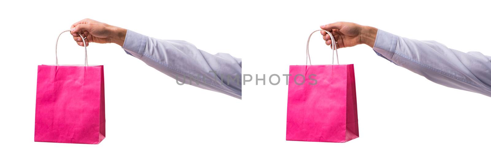 Hand holding shopping bags with christmas shopping on white back