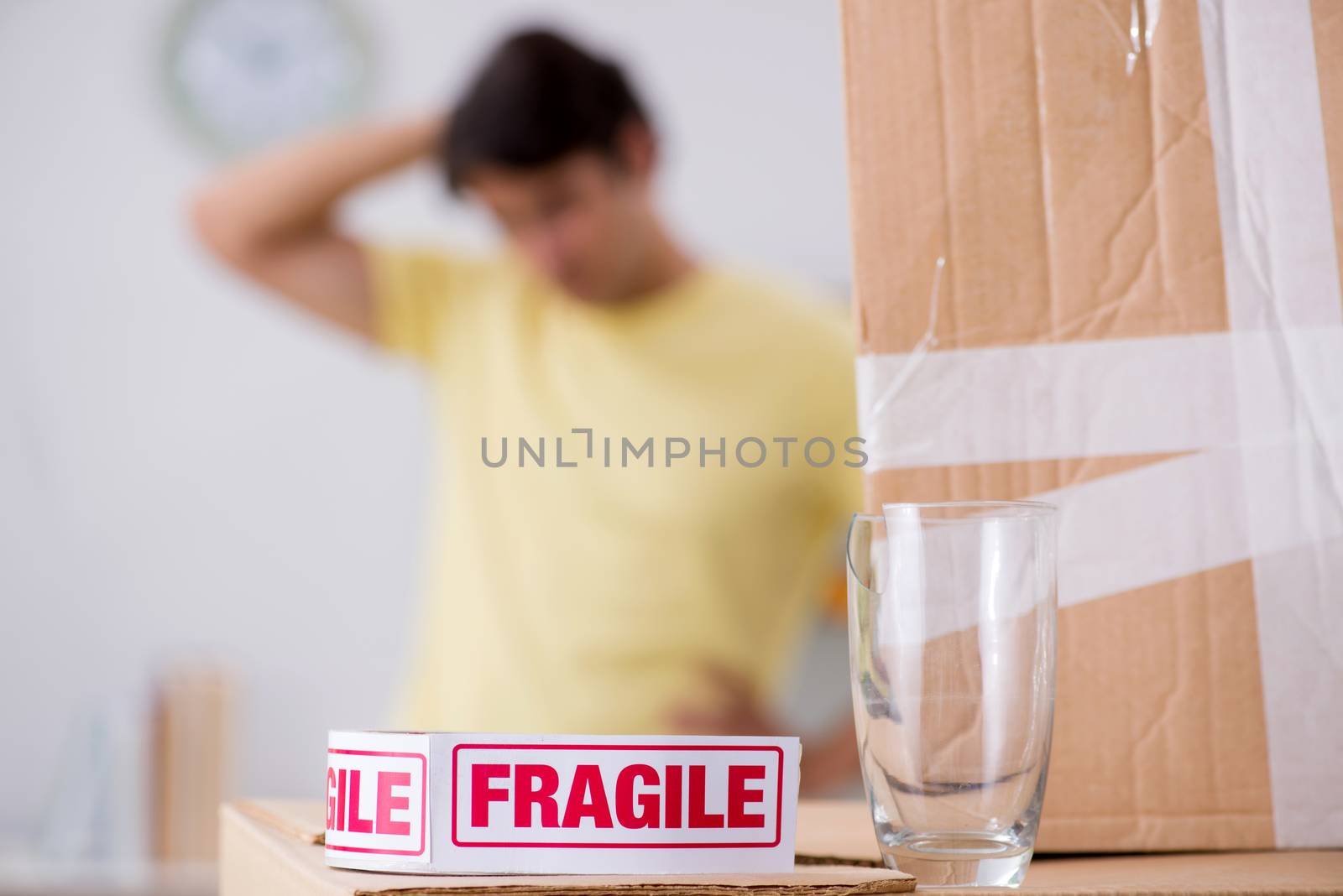 Man moving house and relocating with fragile items