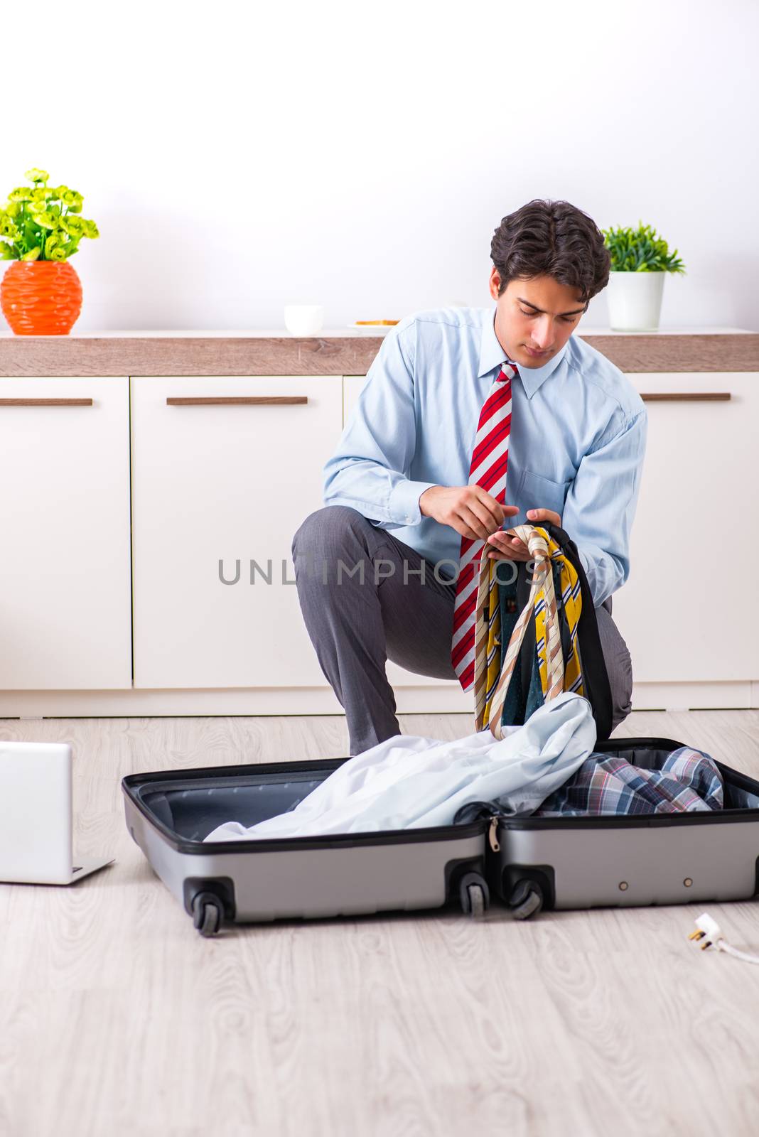 Young handsome businessman preparing for trip