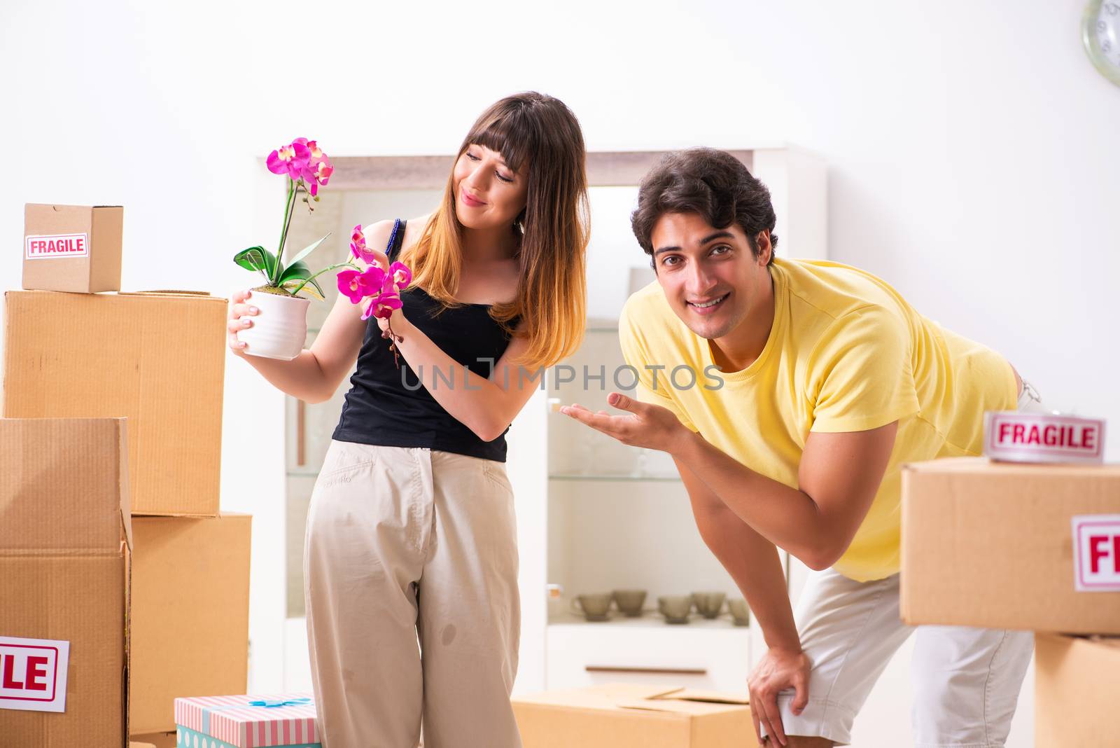 Young pair moving to new flat with fragile things 