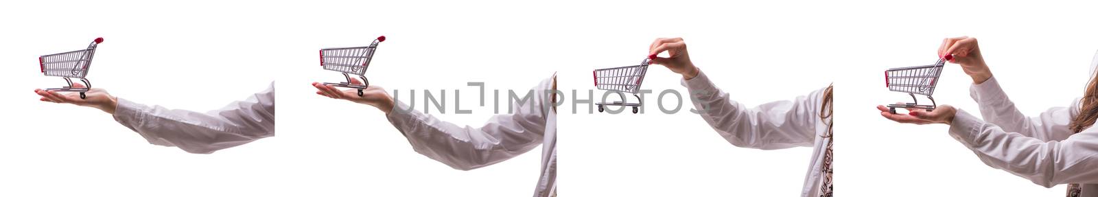 Hand holding shopping cart isolated on white