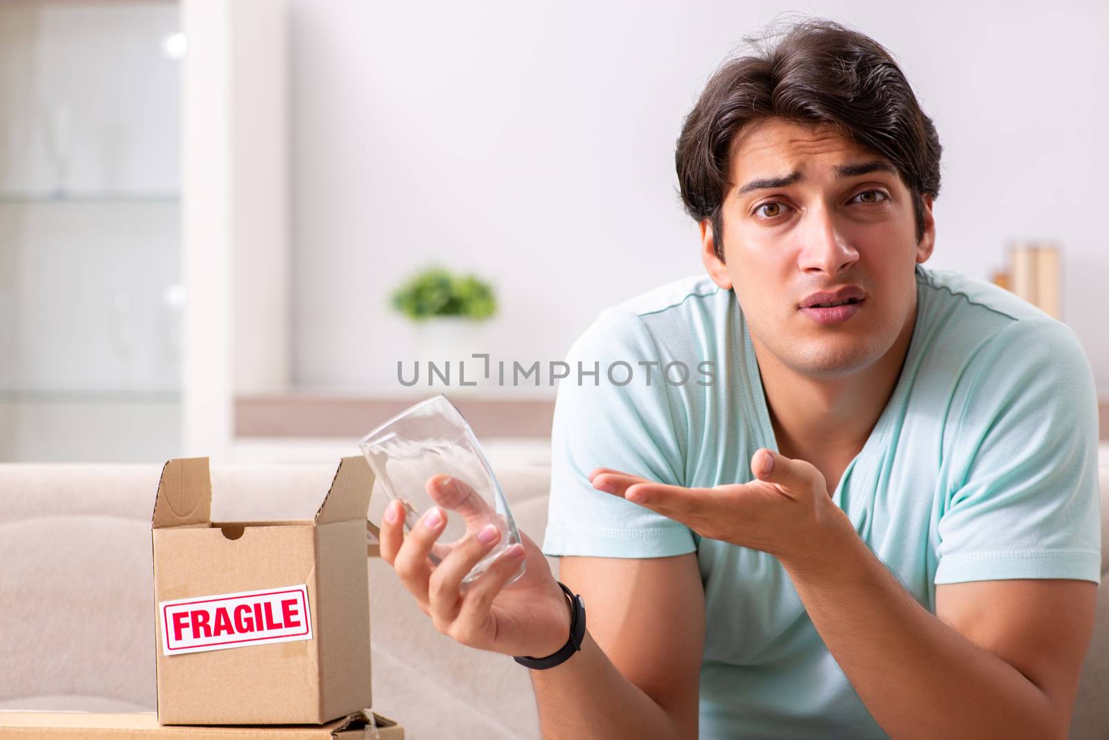 Man opening fragile parcel ordered from internet