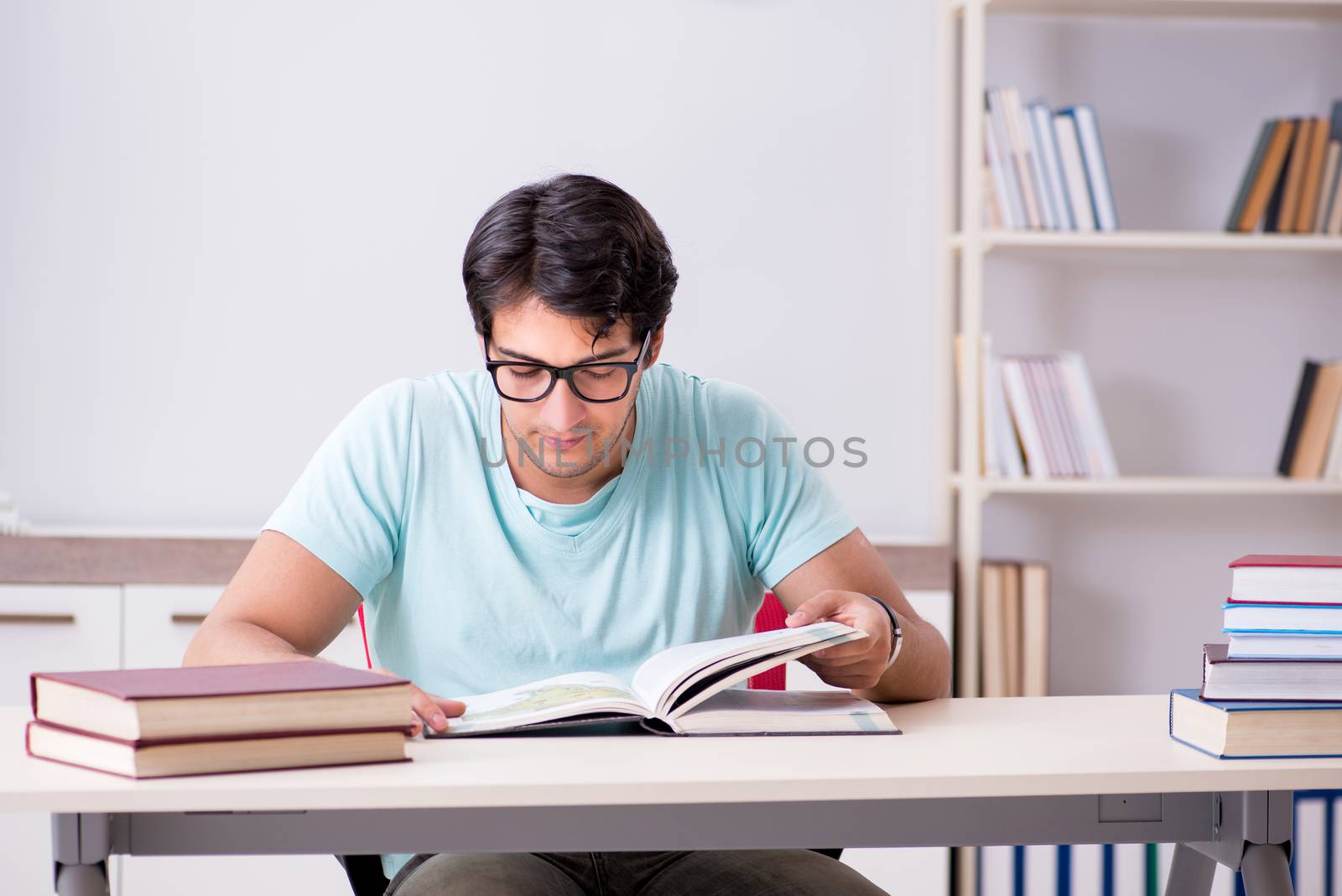 Young handsome student preparing for school exams