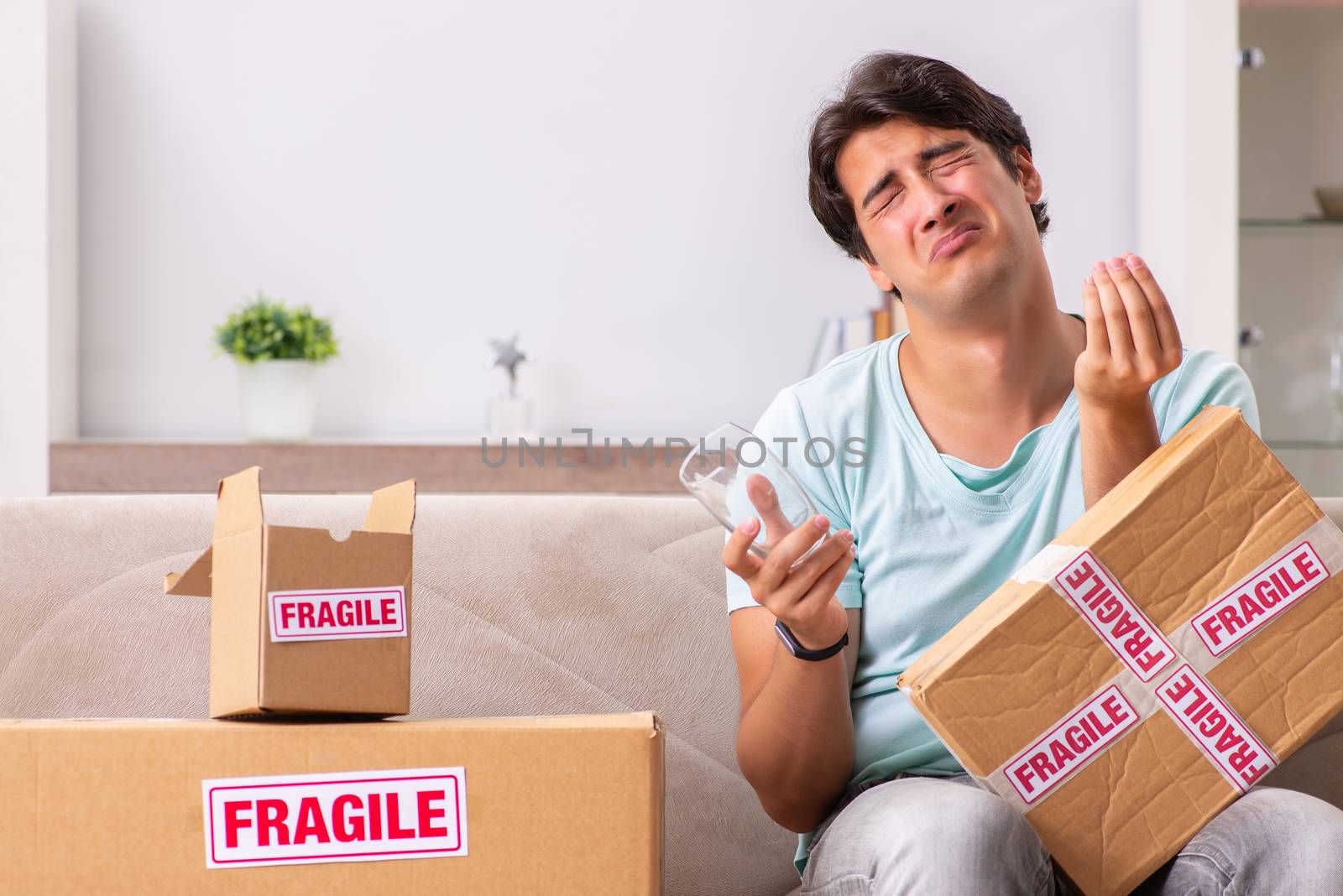 Man opening fragile parcel ordered from internet by Elnur