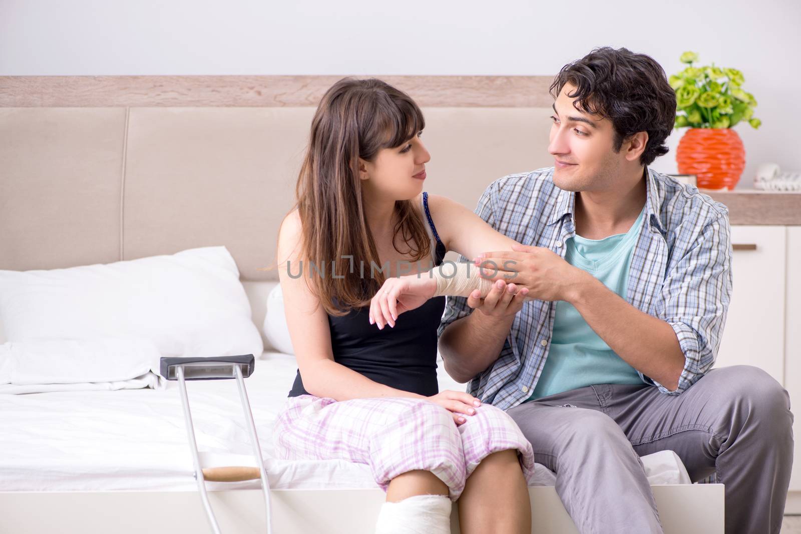 Caring husband looking after his injured wife