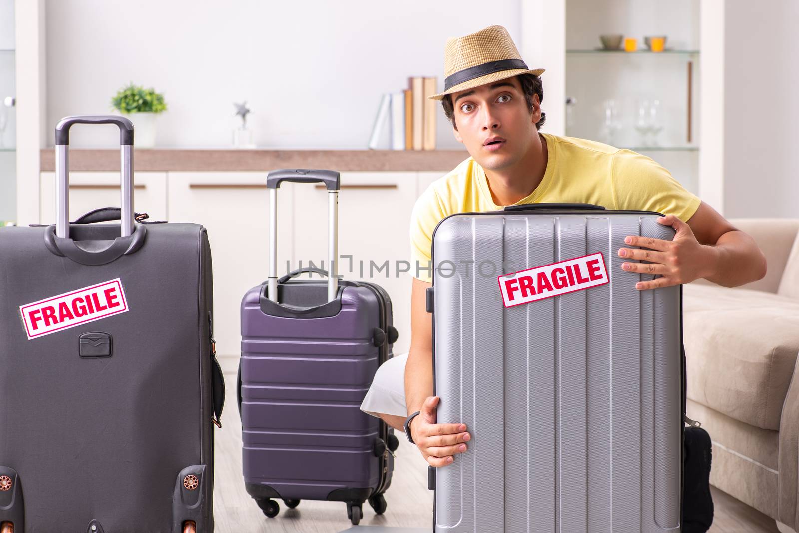 Man going on vacation with fragile suitcases by Elnur